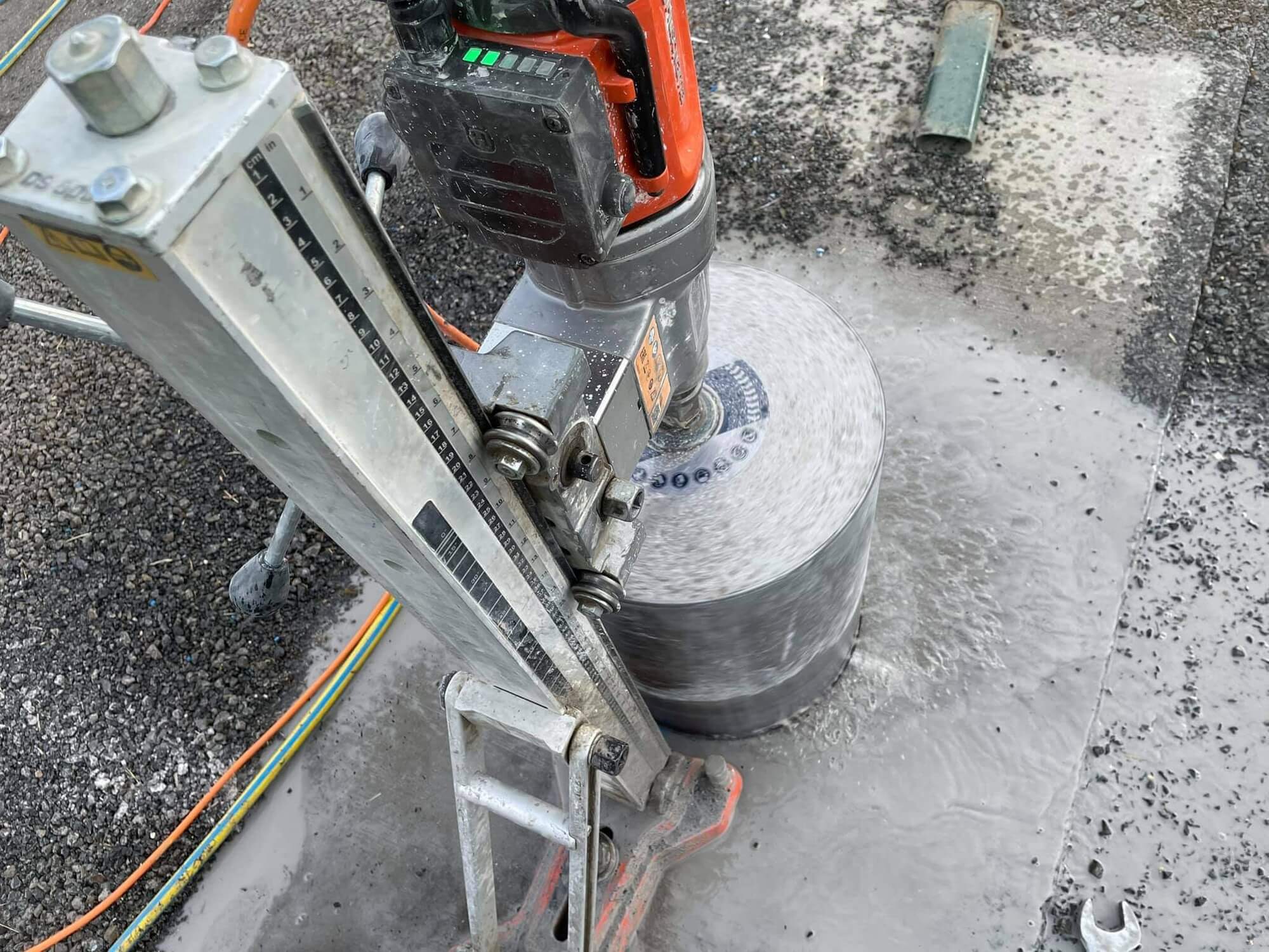 Diamond core barrel cutting a clean round penetration through a concrete slab