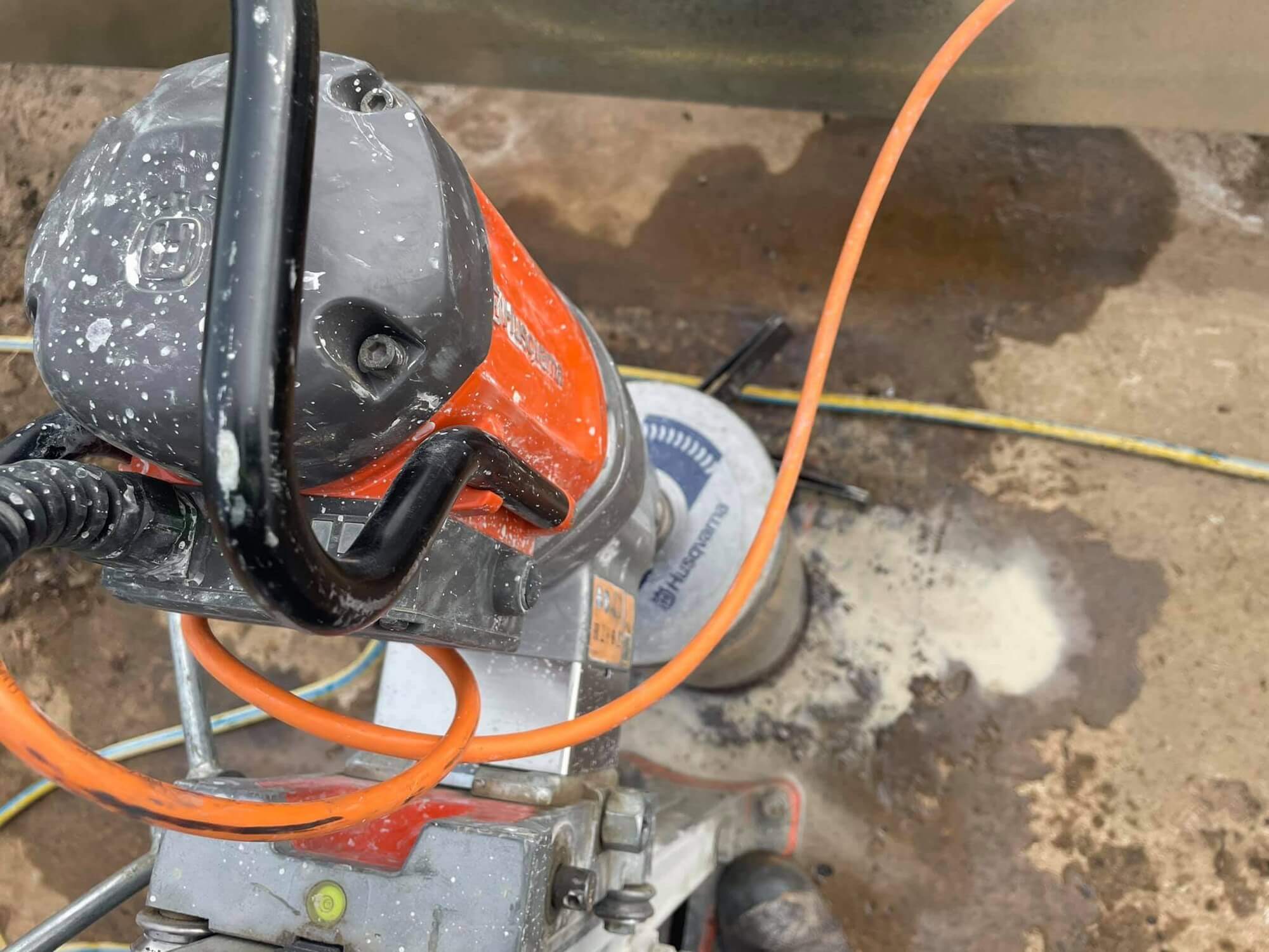 Floor saw blade running a straight cut through a concrete road surface