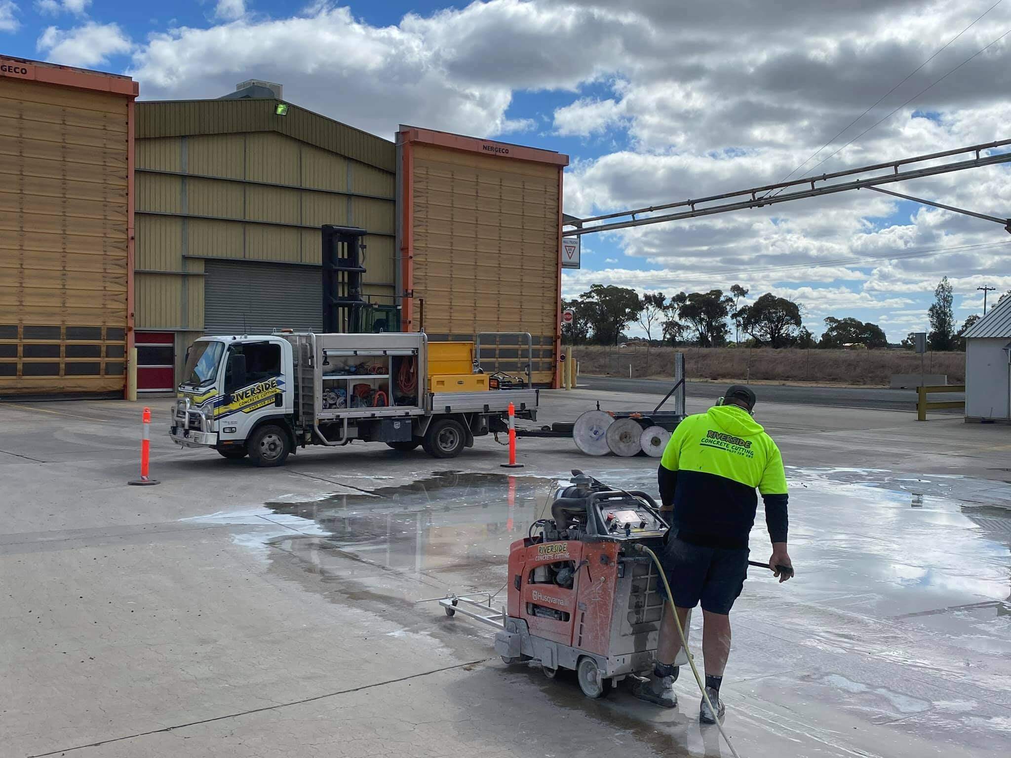 Floor saw running a straight cut across a large concrete slab