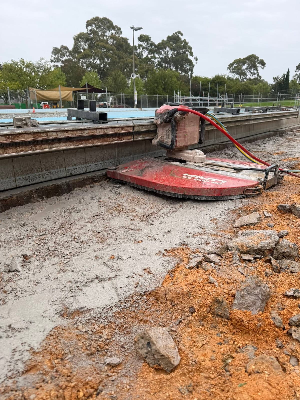 Wall saw set up poolside on a concrete refurbishment job