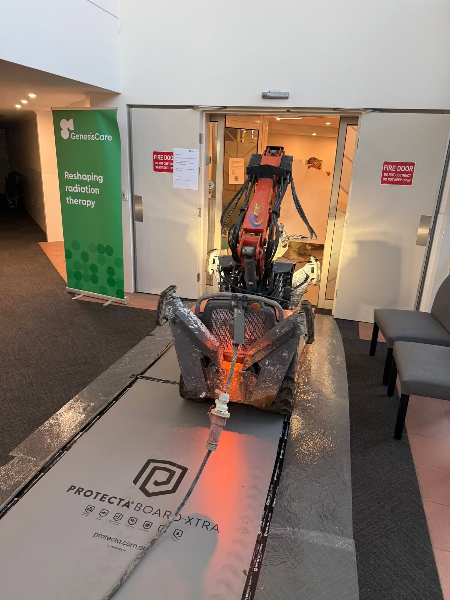 Husqvarna DXR 145 driven out of a lift into a corridor over floor protection