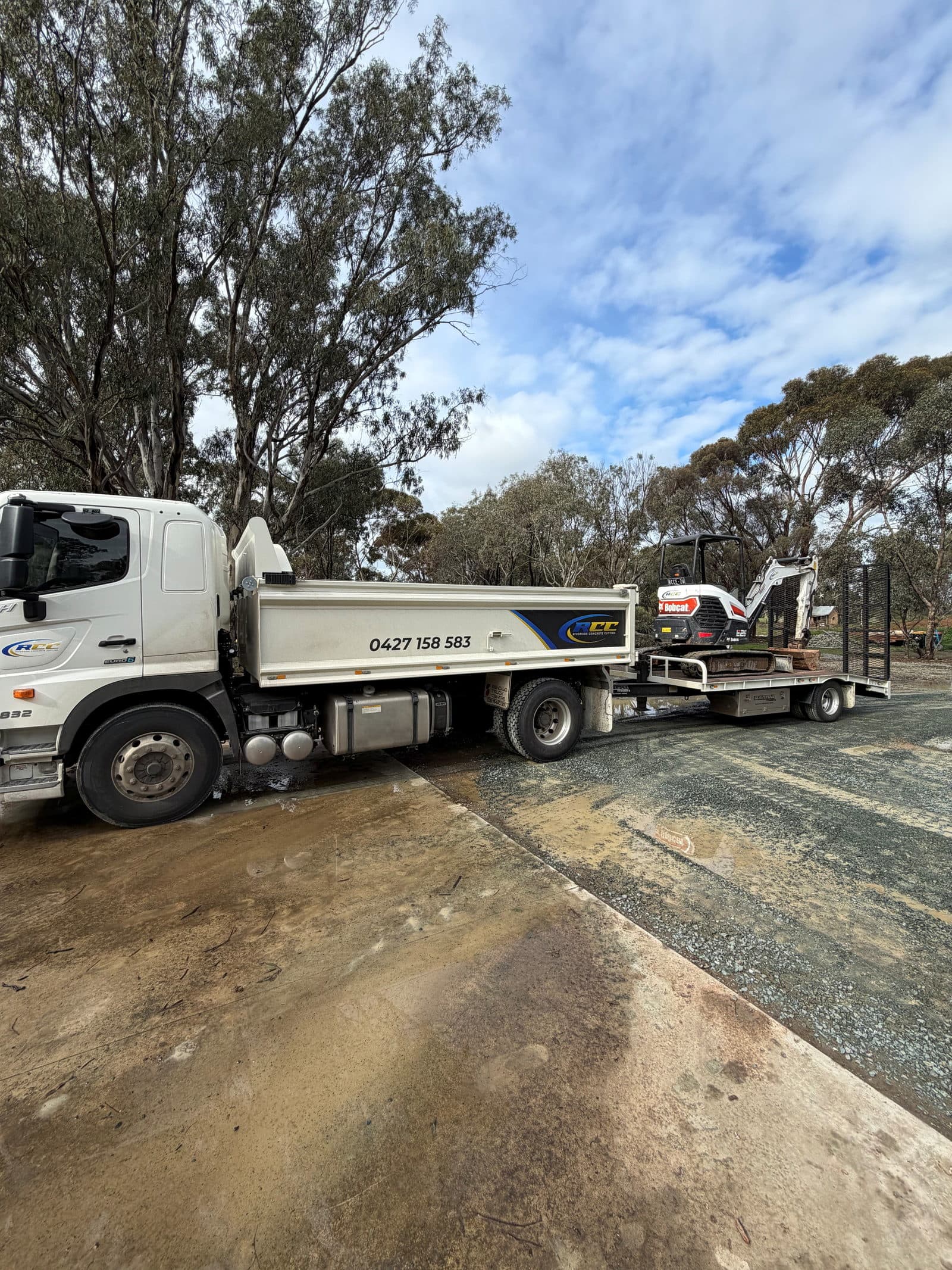 Riverside Concrete Cutting tipper truck and tag trailer loaded with a three tonne excavator
